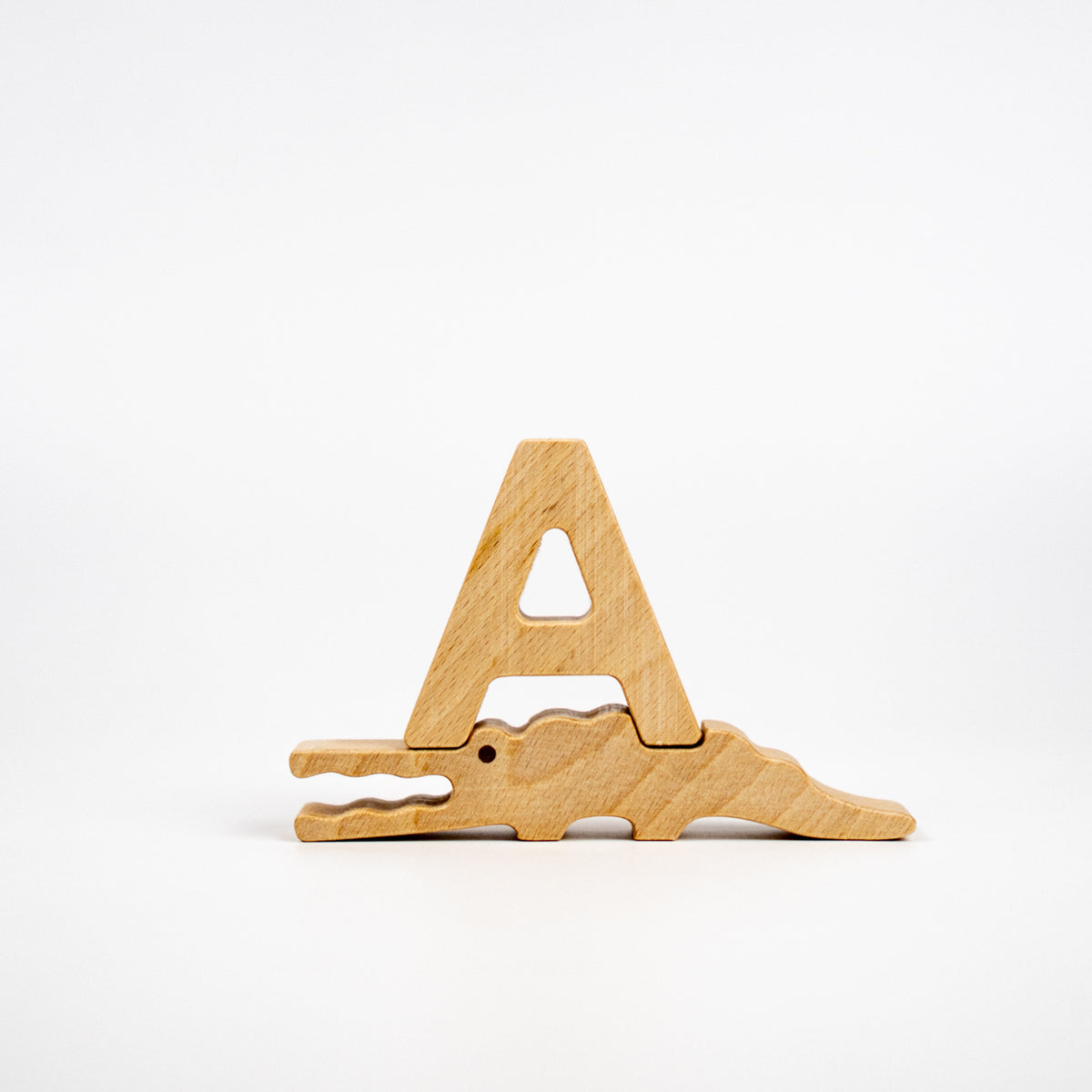 Wooden letter 'A' shaped like a crocodile on a white background
