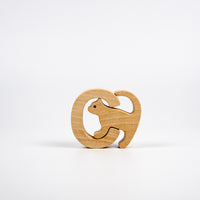 Wooden puzzle piece shaped like a cat on a white background