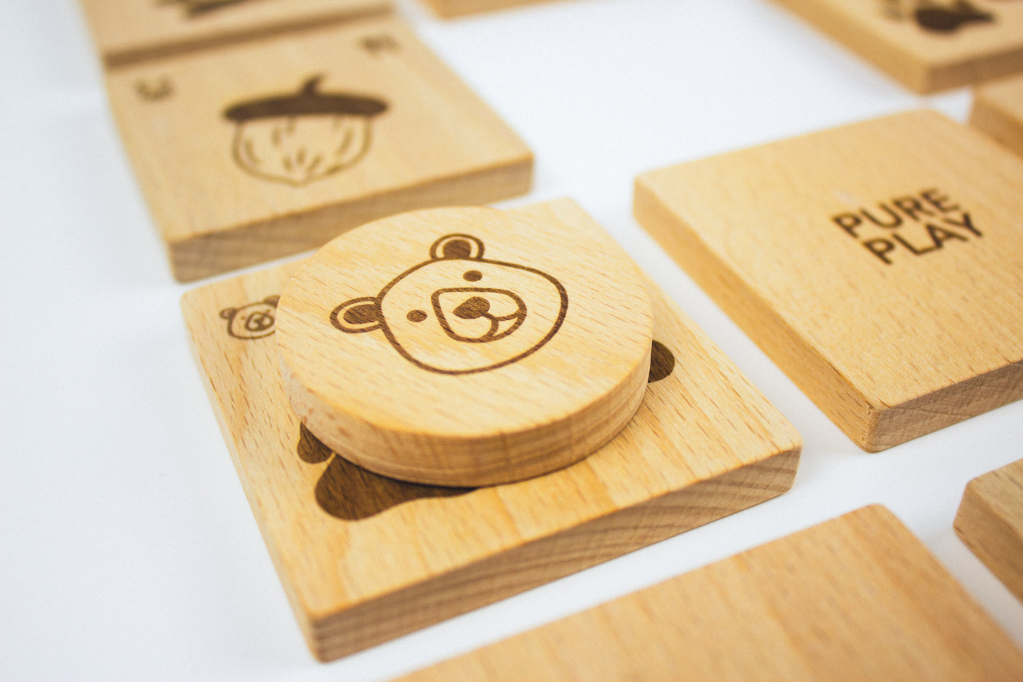 Close-up of a wooden bear memory token from the Forest Animal Rescue game by Pure Play – eco-friendly, handcrafted educational toy.