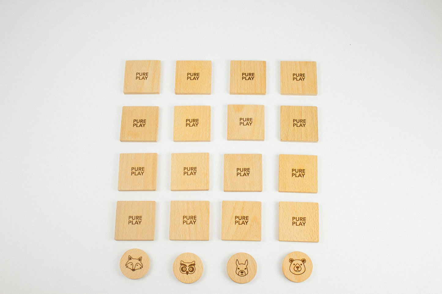 Top-down view of Pure Play wooden memory game – forest-themed cards arranged face-down with animal tokens ready to match.