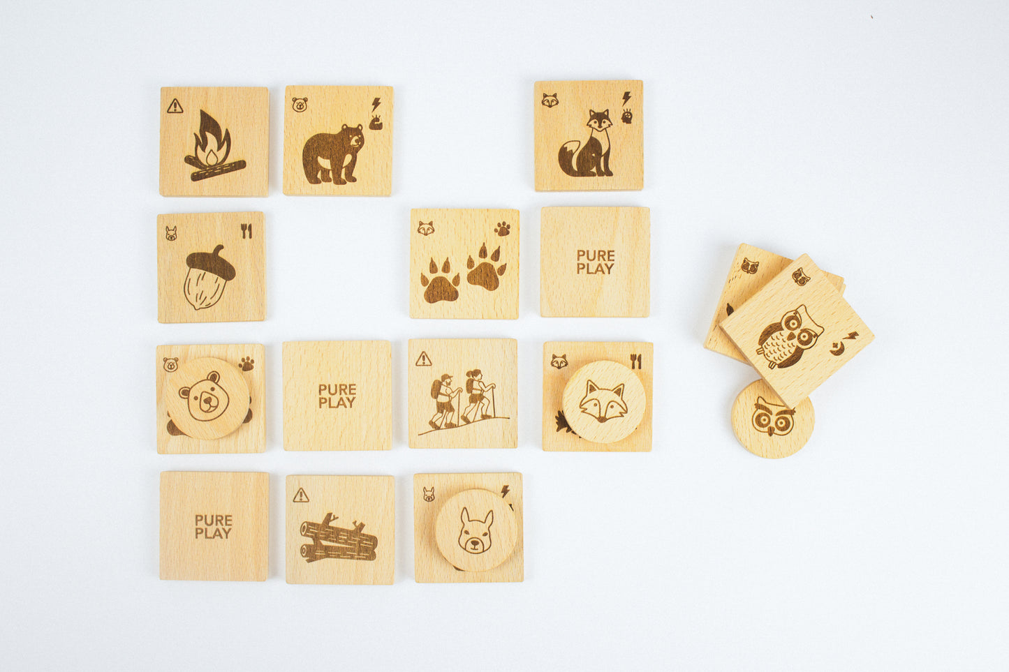 Top-down view of Forest Animal Rescue wooden memory game by Pure Play – nature-inspired symbols and engraved animal tokens for kids.