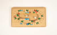 Wooden board game with pieces and dice on a light beige background