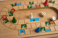 Close-up of a board board game with pieces and dice on a wooden surface