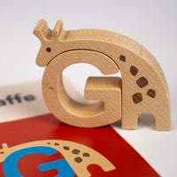 Wooden letter 'G' shaped like a giraffe on a white background