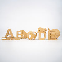 Wooden alphabet letters with animal designs on a white background