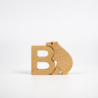 Wooden letter 'B' with a bear design on a white background