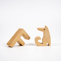 Two wooden fox shapes on a white background