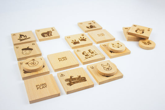 Wooden forest-themed memory matching game pieces arranged on white background – handcrafted by Pure Play using natural beechwood.
