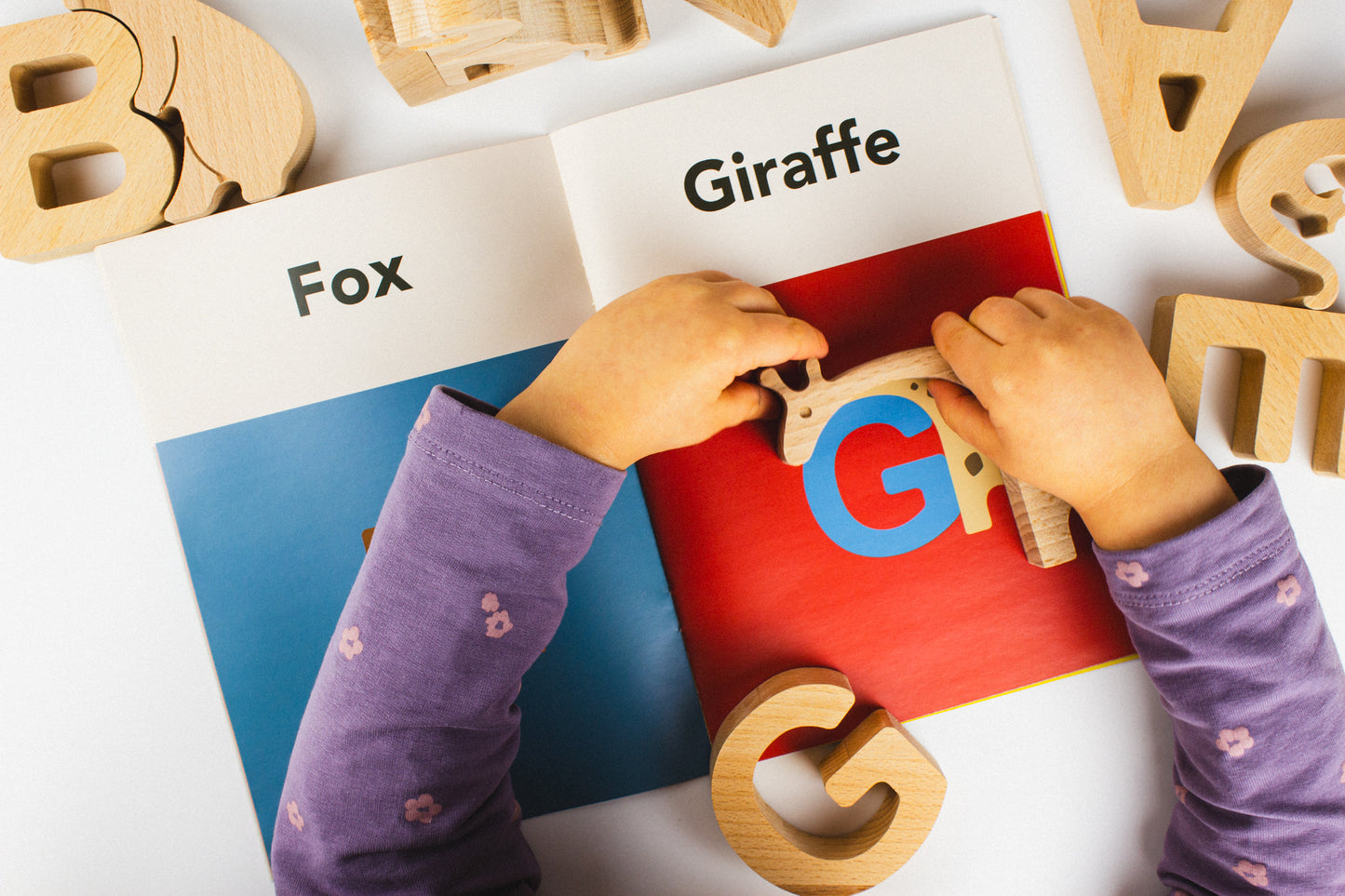 Playing. Montessori Wooden Alphabet Puzzle Set with Animal Figurines. Made in Romania.