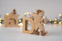 Wooden figures of a drummer boy with blurred lights in the background