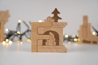 Wooden puzzle piece with a clock design  and fireplaceon a blurred festive background