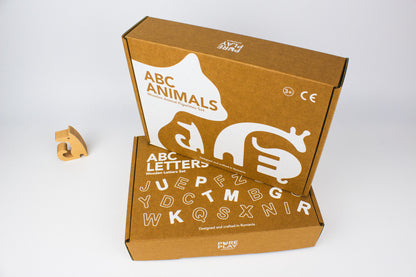 Cardboard box. Montessori Wooden Alphabet Puzzle Set with Animal Figurines. Made in Romania.